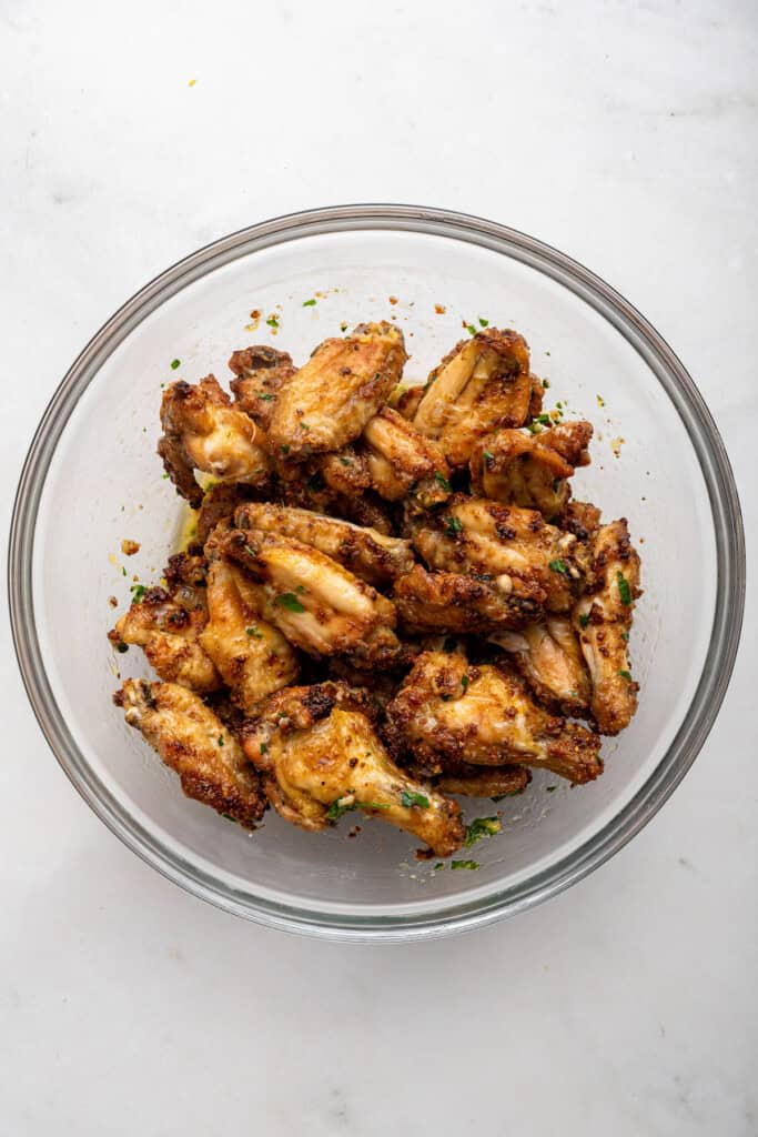 Overhead view of lemon pepper wings in mixing bowl