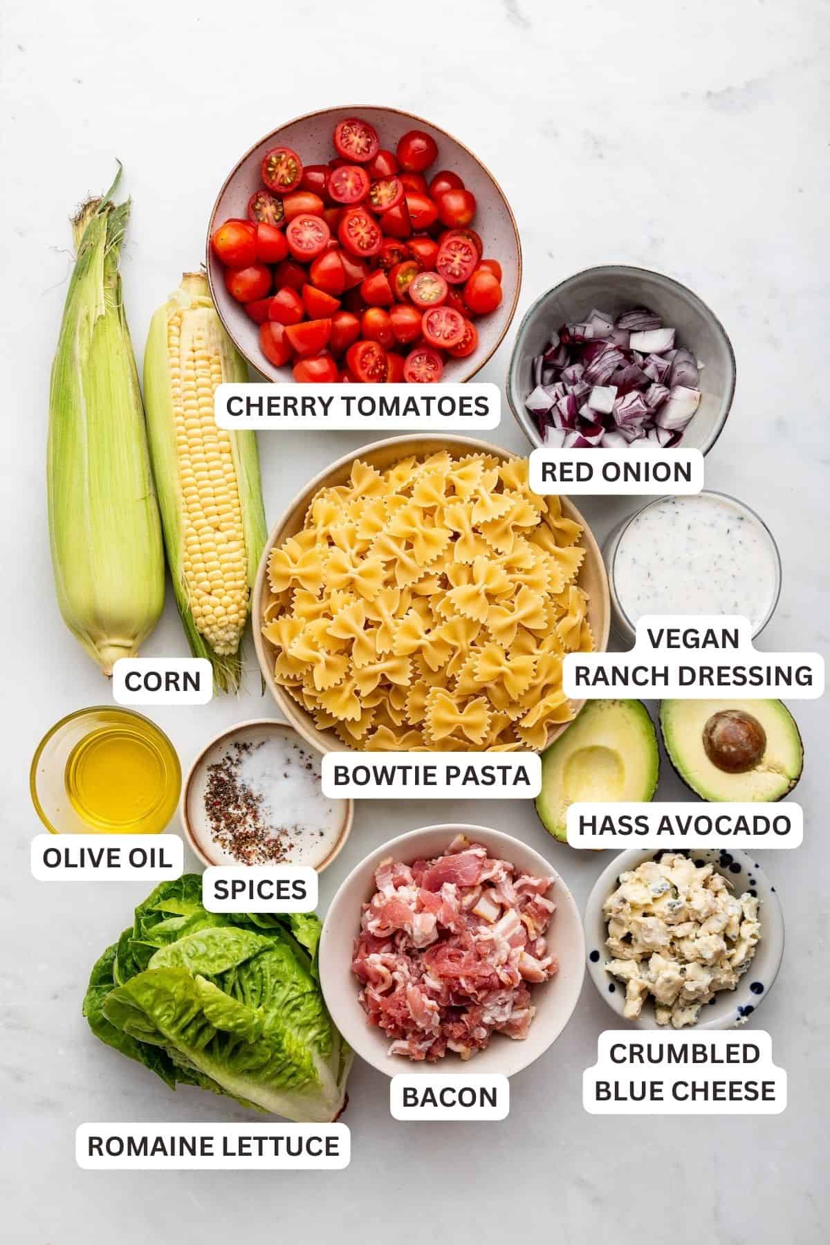 Overhead view of ingredients for BLT pasta salad with labels