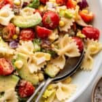 Creamy BLT pasta salad in bowl with spoons for serving