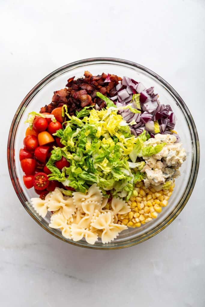 Overhead view of ingredients for BLT pasta salad in mixing bowl