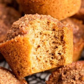 Cinnamon muffin with bite taken out to show moist, light texture