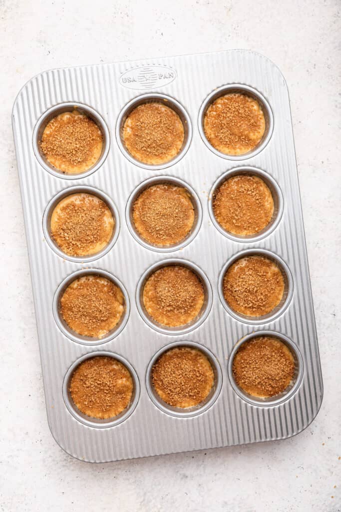 Overhead view of cinnamon muffins in pan before baking