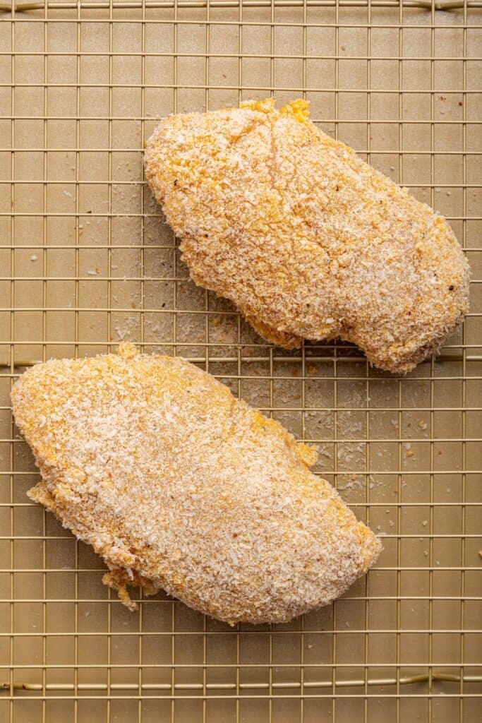 Overhead view of garlic Parmesan chicken on wire rack before baking