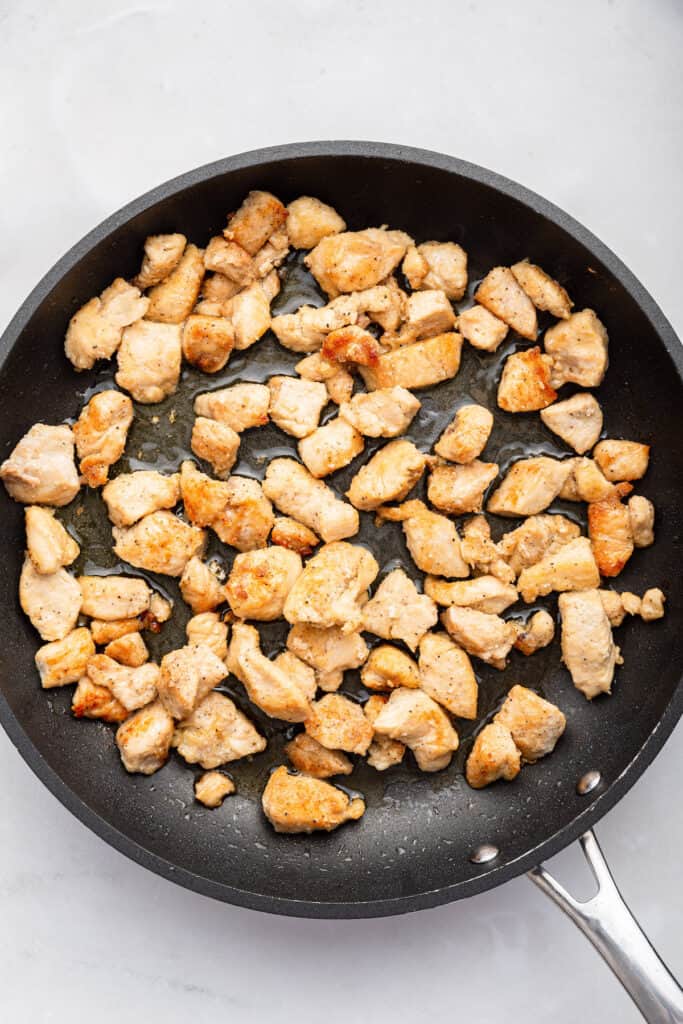 Overhead view of cooked chicken in skillet