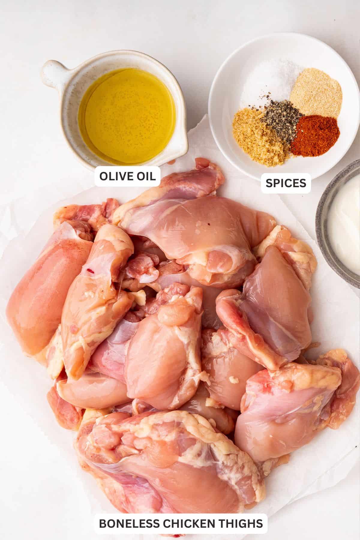 Overhead view of ingredients for baked boneless chicken thighs with labels