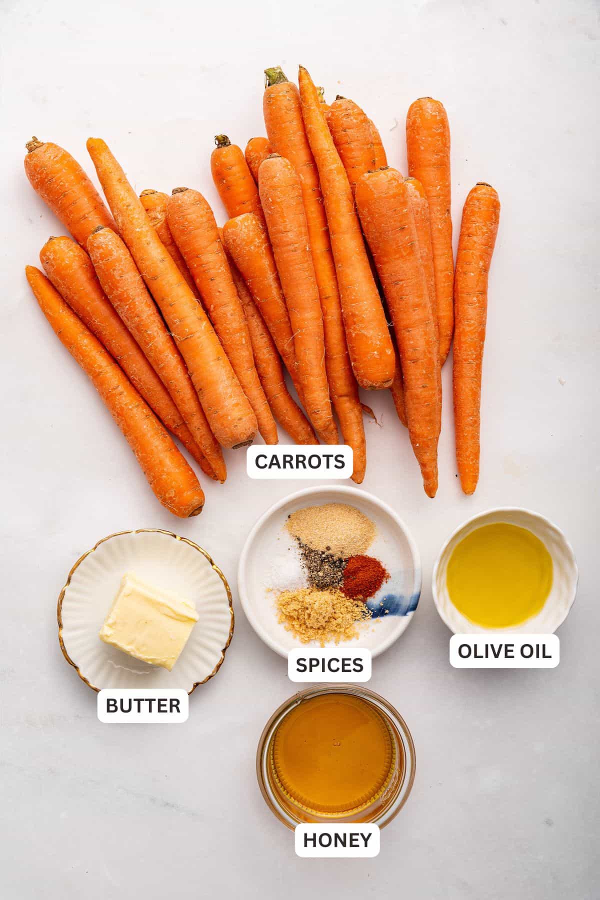 Overhead view of ingredients for honey roasted carrots with labels