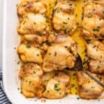 Baking dish with baked boneless chicken thighs