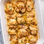 Overhead view of baked boneless chicken thighs in baking dish