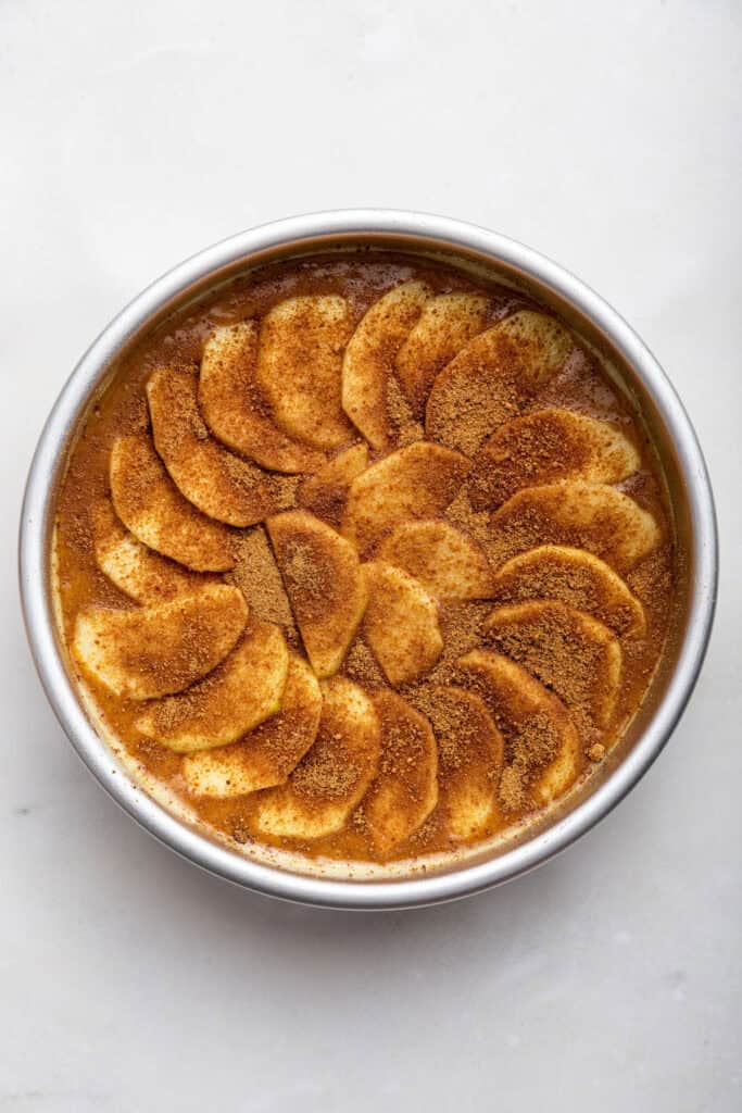 Overhead view of German apple cake in pan before baking