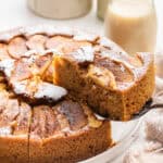 Lifting slice of German apple cake from platter