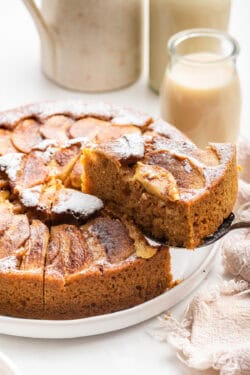 Lifting slice of German apple cake from platter