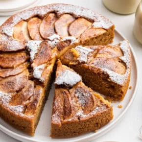 German apple cake on platter with two slices cut