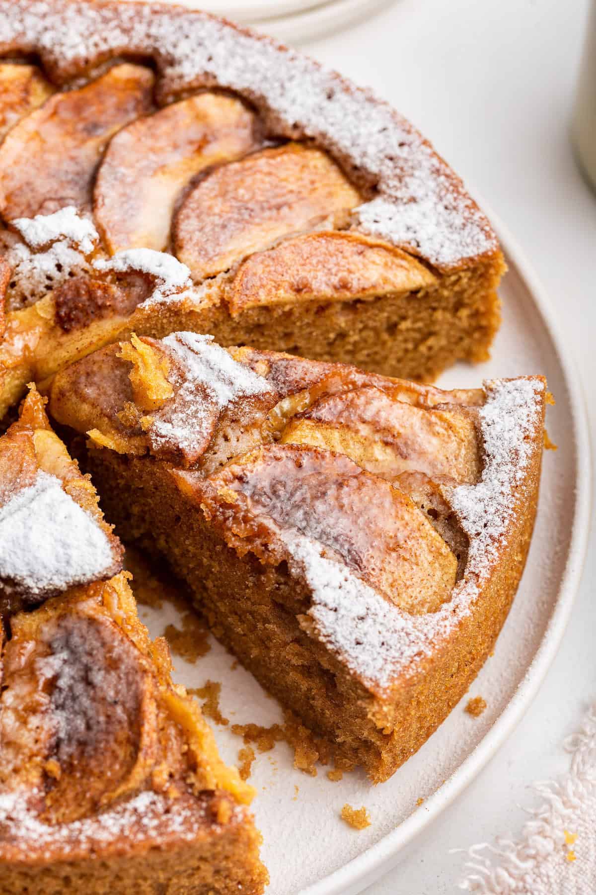 Sliced German apple cake on cake stand