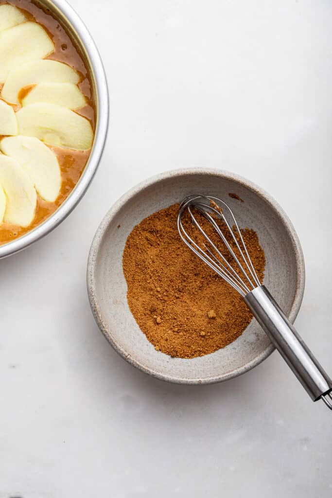 Cinnamon sugar mixture in bowl with whisk