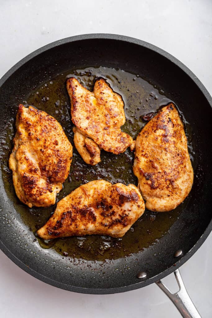 Pan-fried chicken in skillet