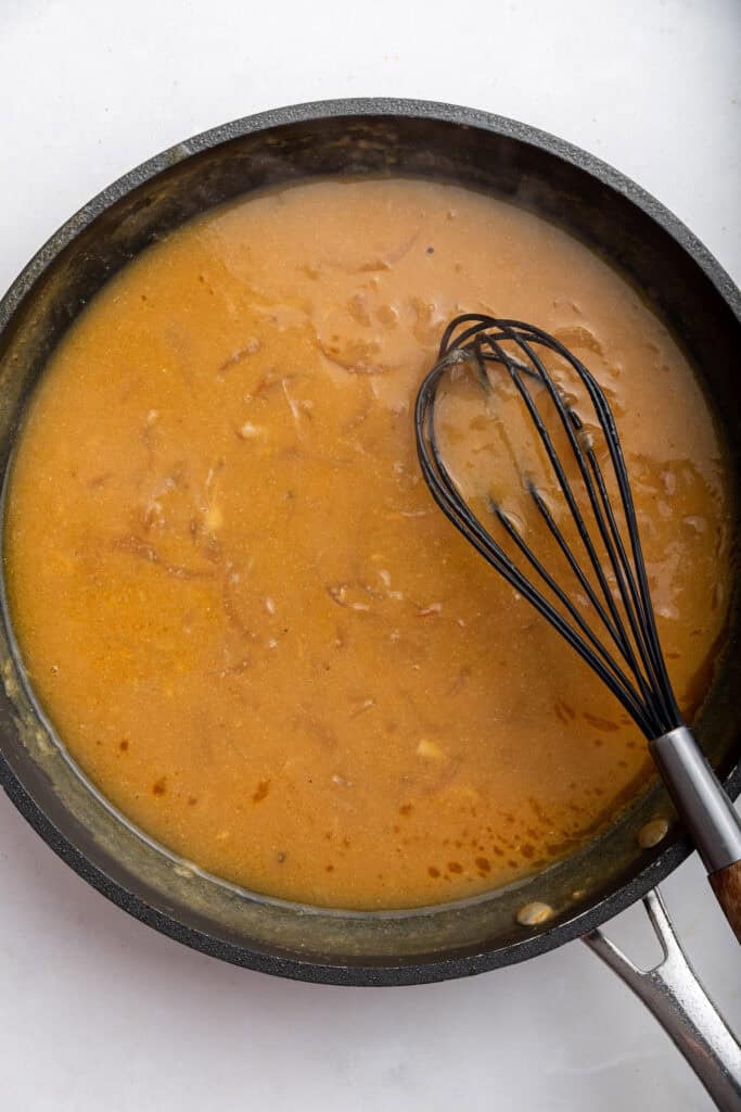 Onion gravy with whisk in skillet