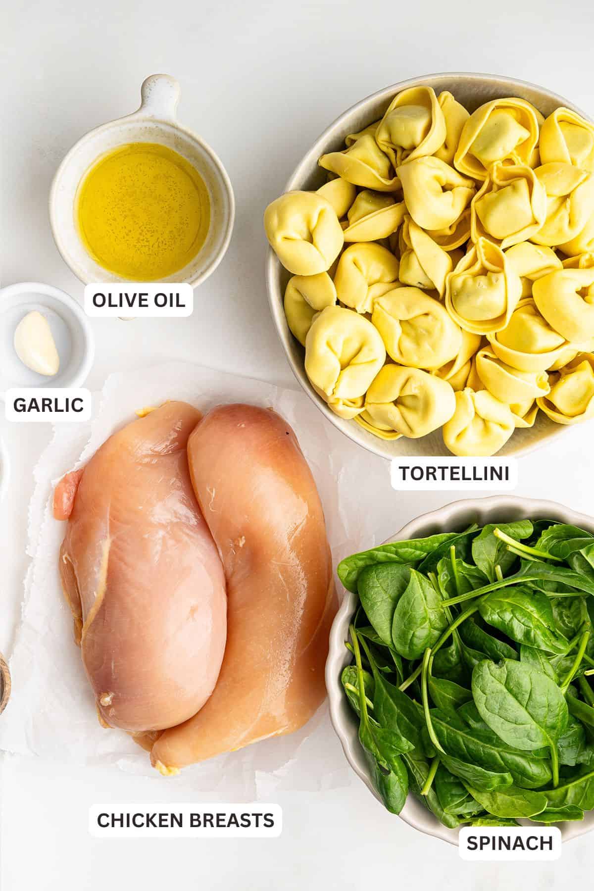 Overhead view of ingredients for chicken tortellini Alfredo with labels