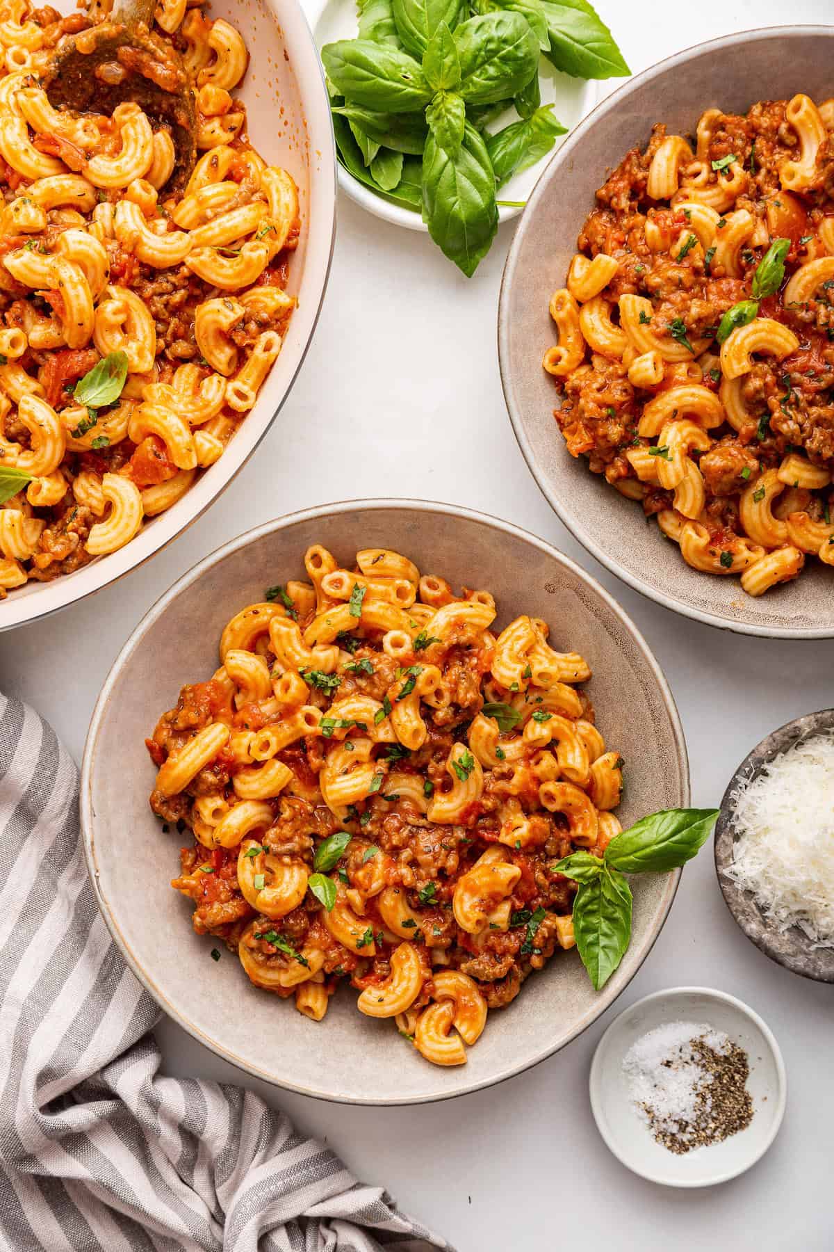 Beefaroni recipe in 2 bowls and skillet