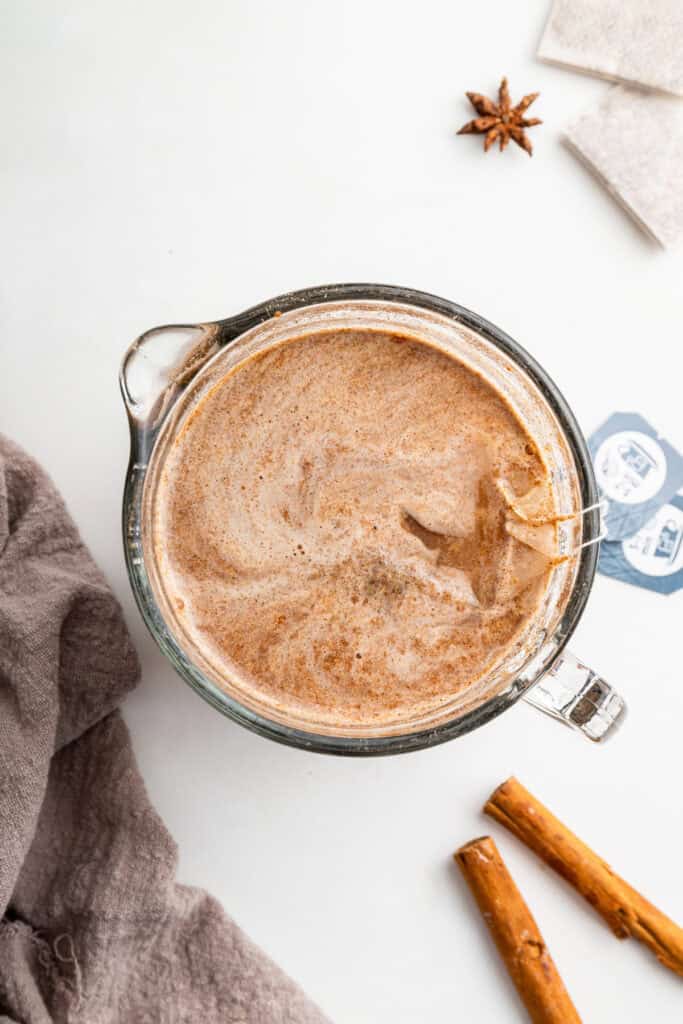 Overhead view of chai concentrate in liquid measuring cup