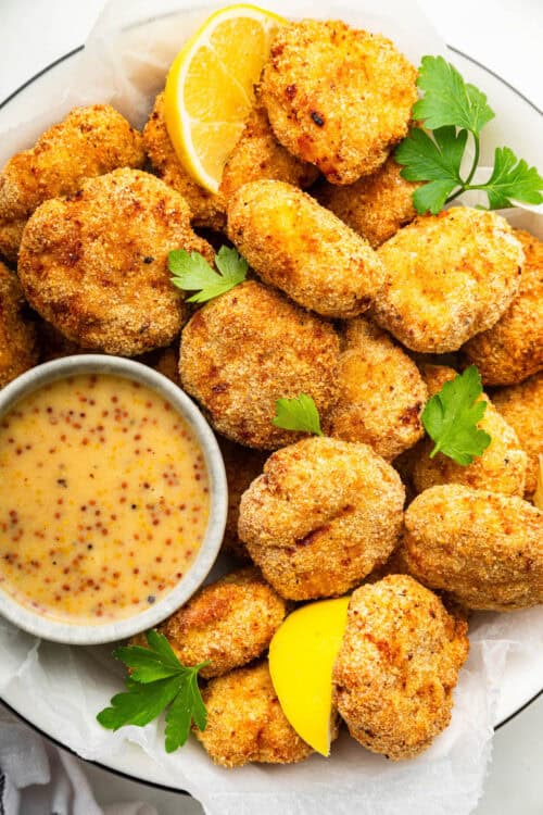 Plate of homemade chicken nuggets with dipping sauce