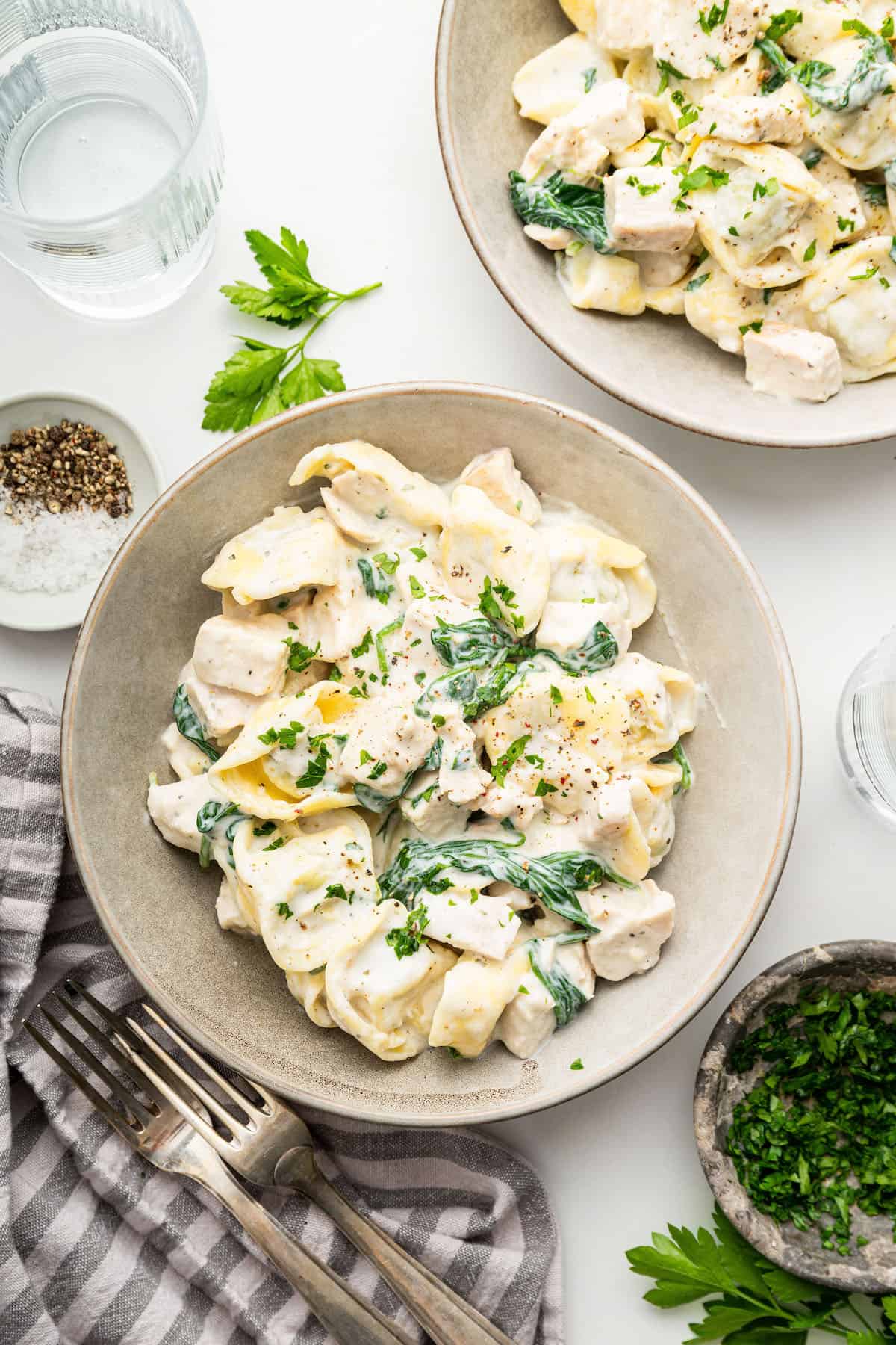 Overhead view of chicken tortellini Alfredo in 2 bowls