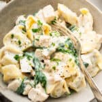 Bowl of chicken tortellini Alfredo with fork