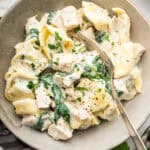 Chicken tortellini Alfredo in bowl with fork