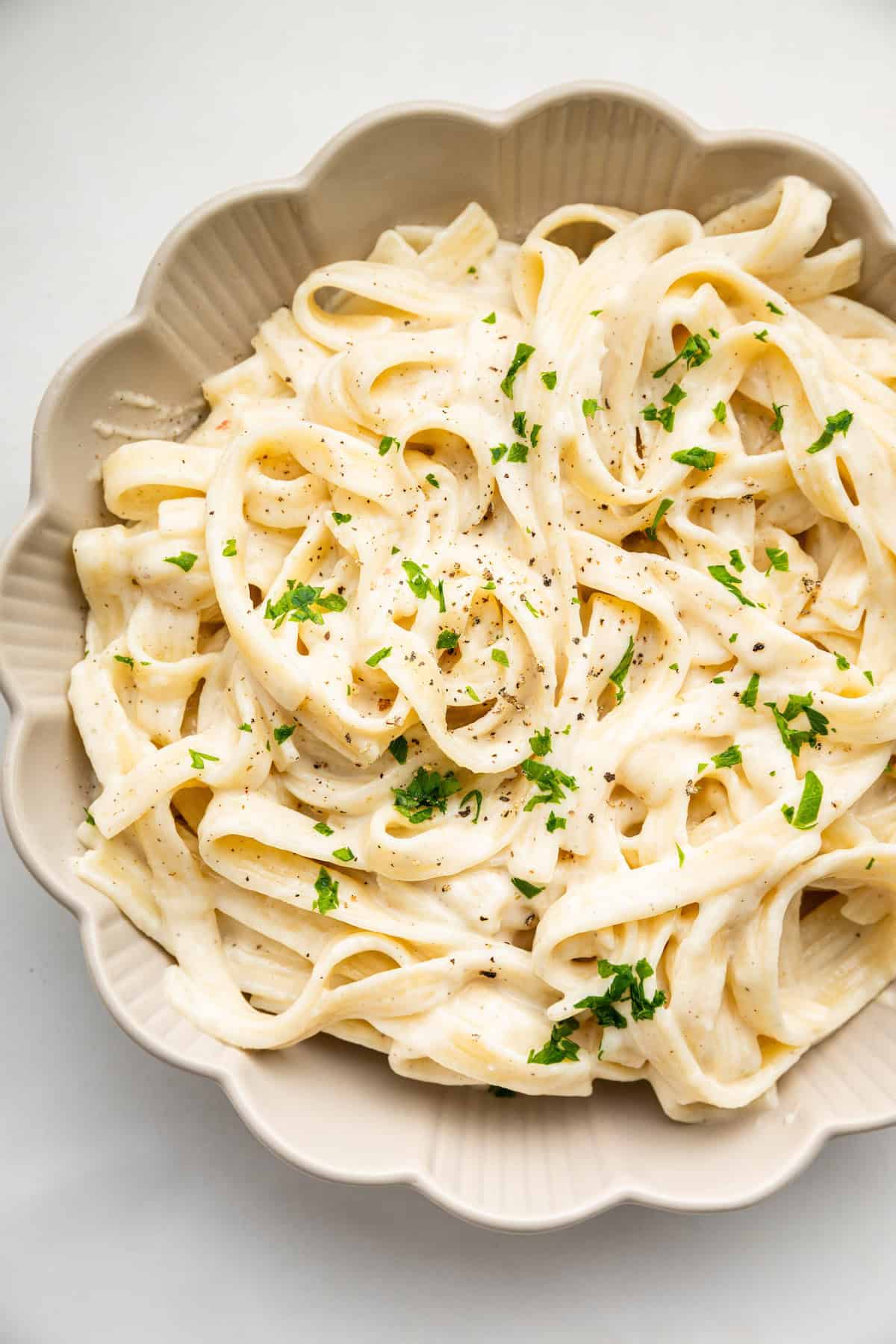 Overhead view of cottage cheese Alfredo sauce with fettuccine in bowl