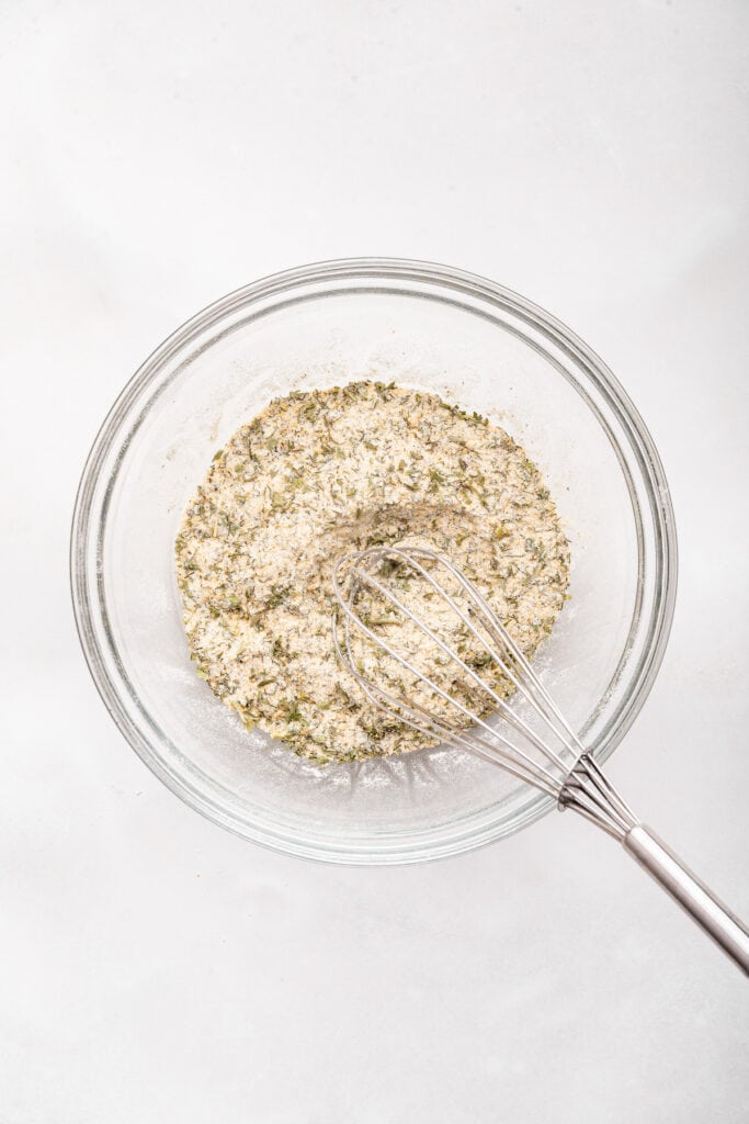 Ranch seasoning in bowl with whisk