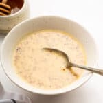 Bowl of honey mustard dipping sauce with spoon