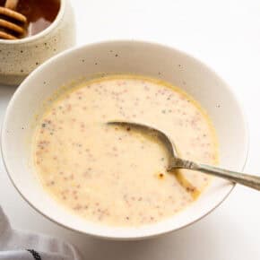 Bowl of honey mustard dipping sauce with spoon