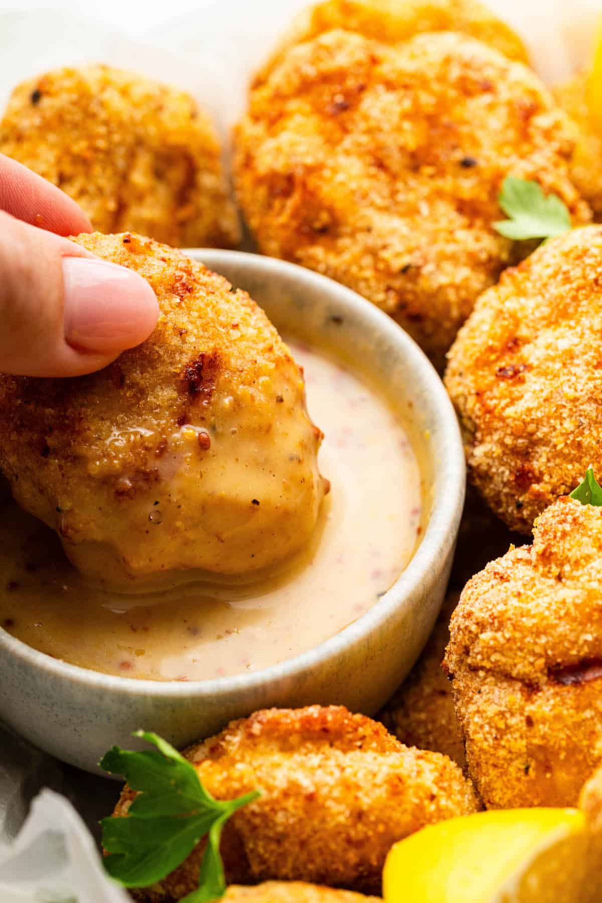 Dipping nugget in honey mustard dipping sauce