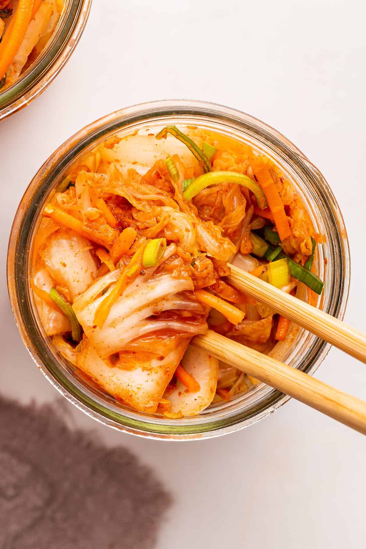 Chopsticks in jar of kimchi