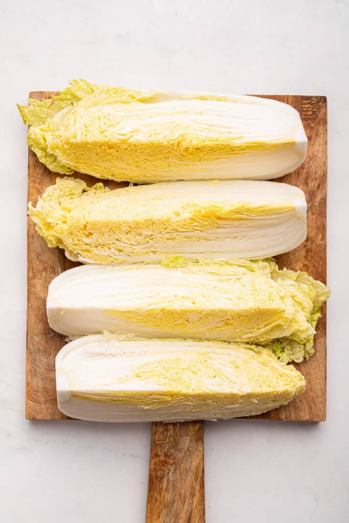 Quartered napa cabbage on cutting board