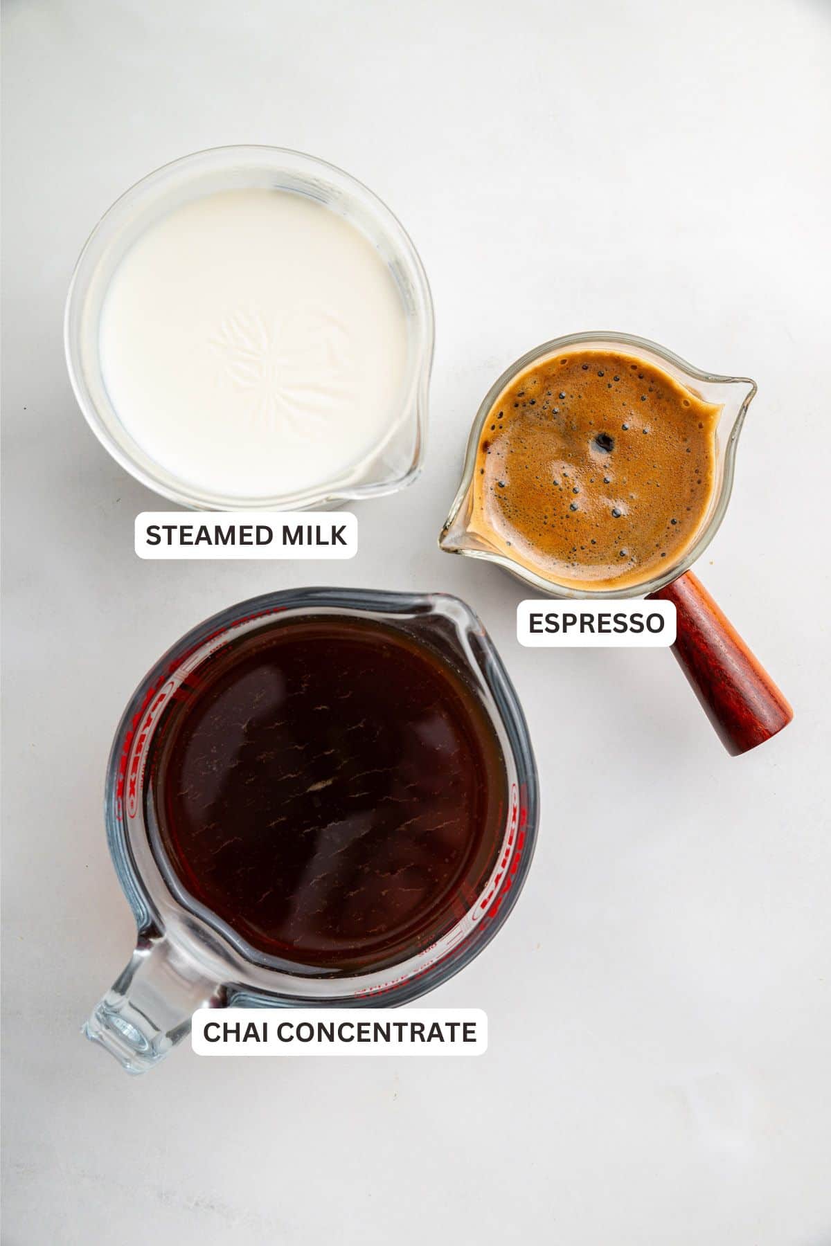 Overhead view of ingredients for dirty chai latte with labels