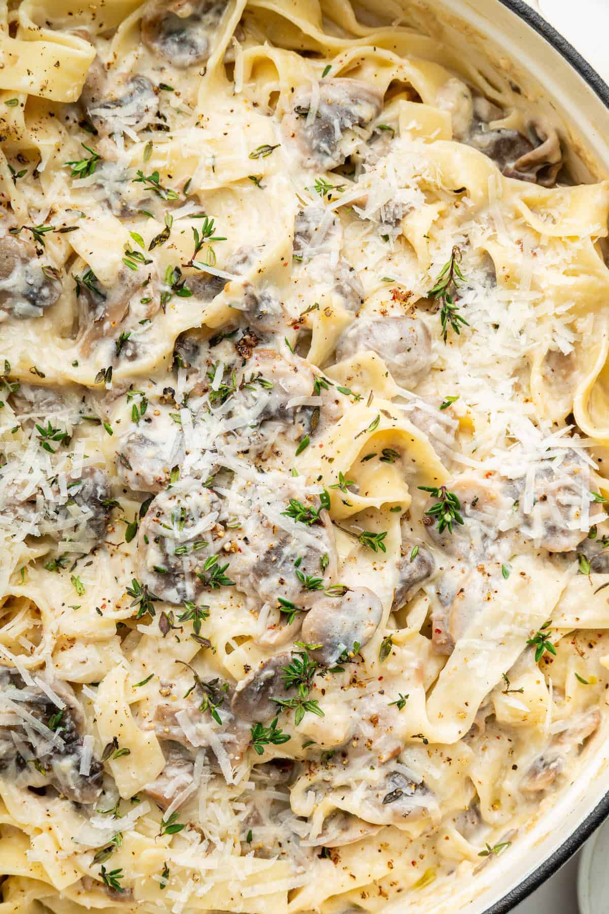 Overhead view of creamy mushroom pasta in pan