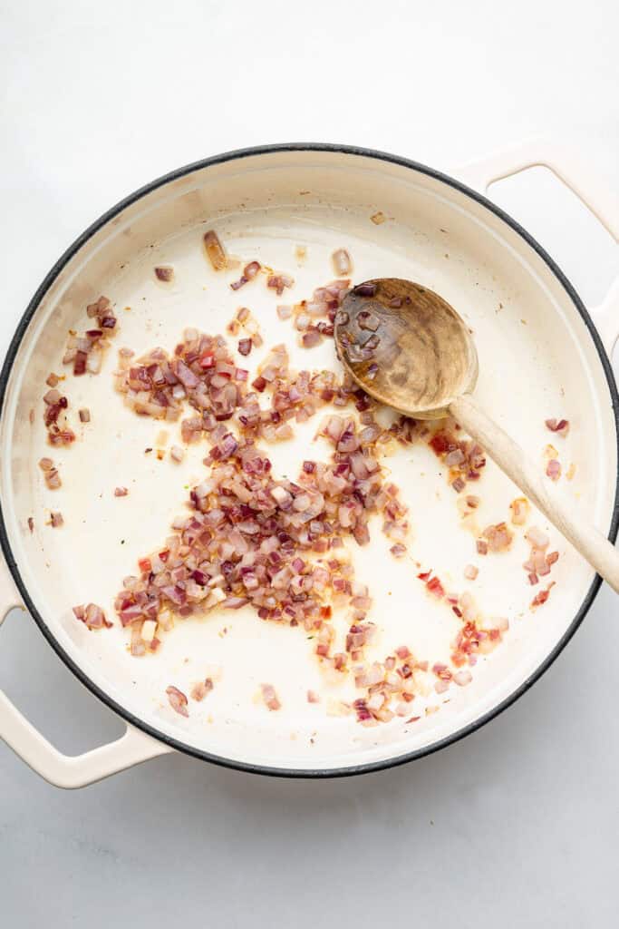 Diced red onion cooking in pan