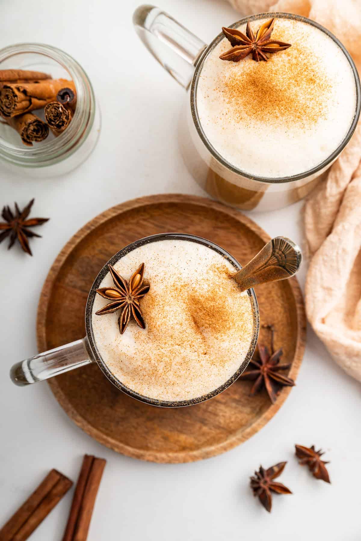 Overhead view of dirty chai lattes in glass mugs