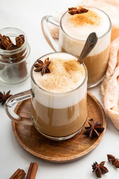 Two dirty chai lattes in glass mugs