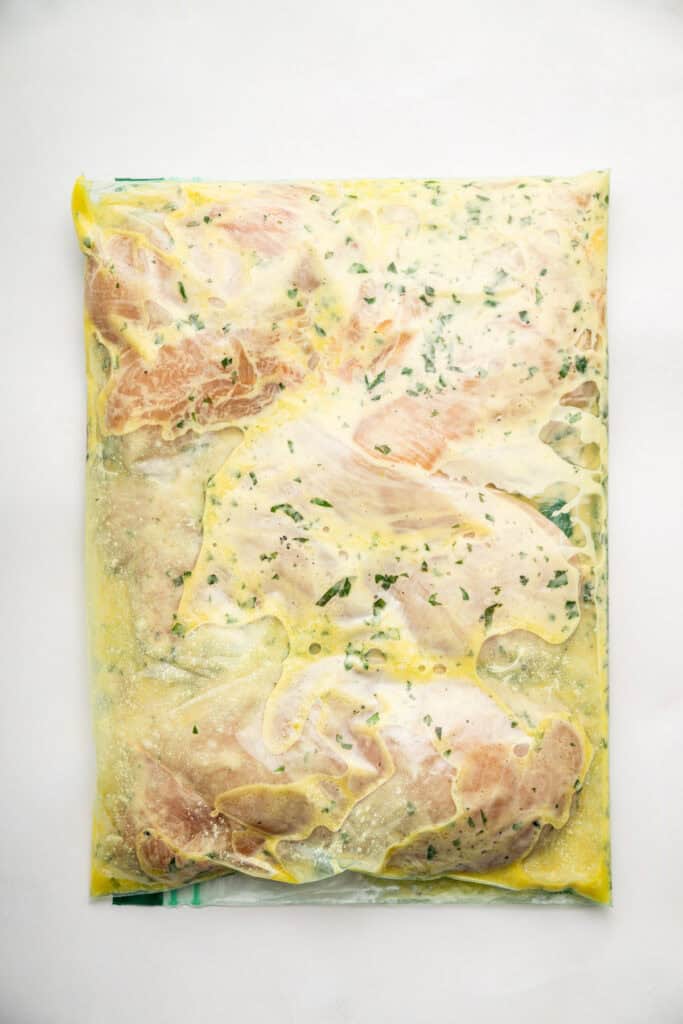 Chicken marinating in a ziplock bag.