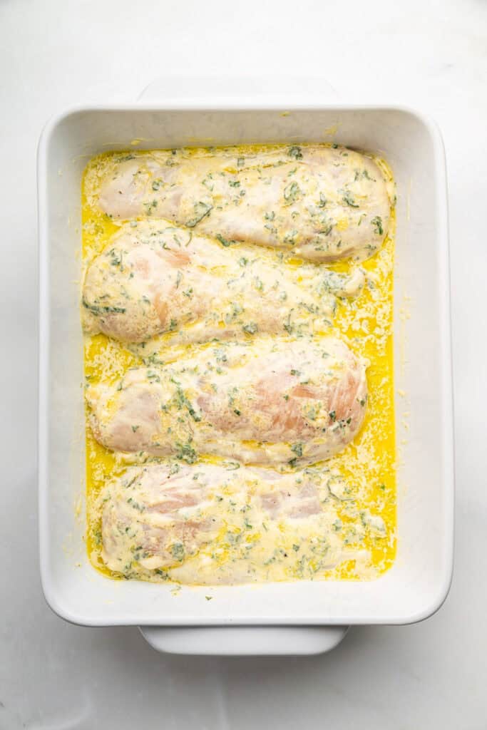 Marinated chicken breasts in a baking dish.