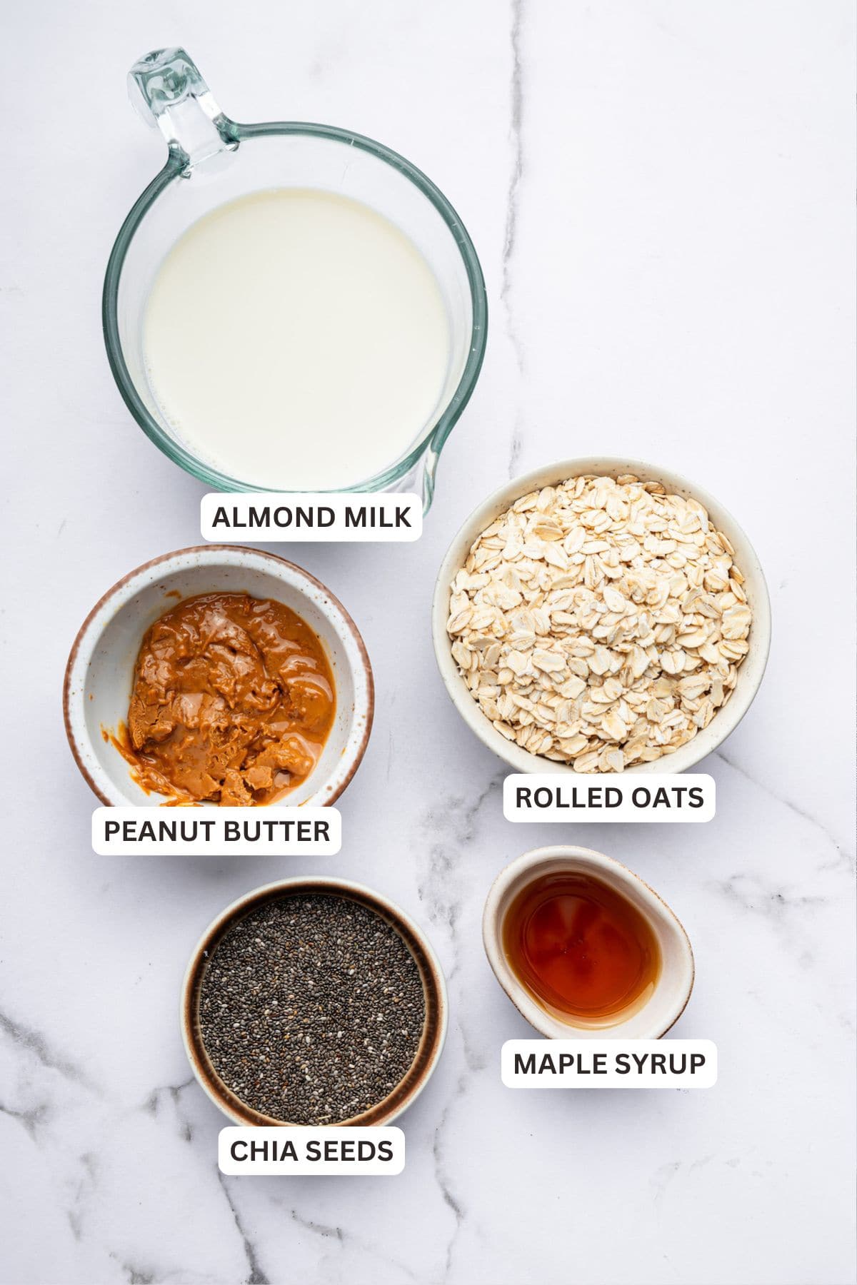 Overhead view of ingredients for peanut butter overnight oats with labels