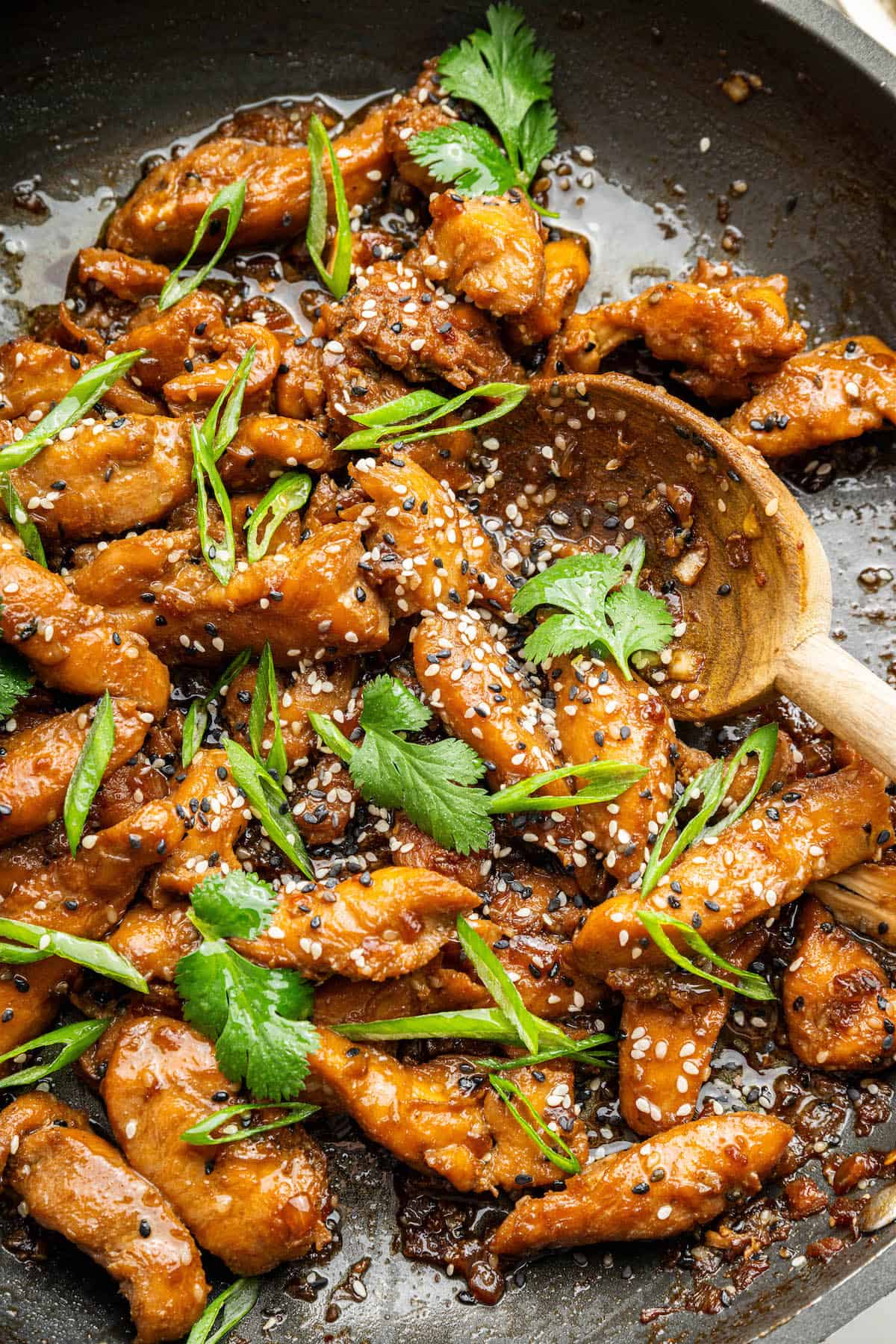 Stirring chicken bulgogi in skillet