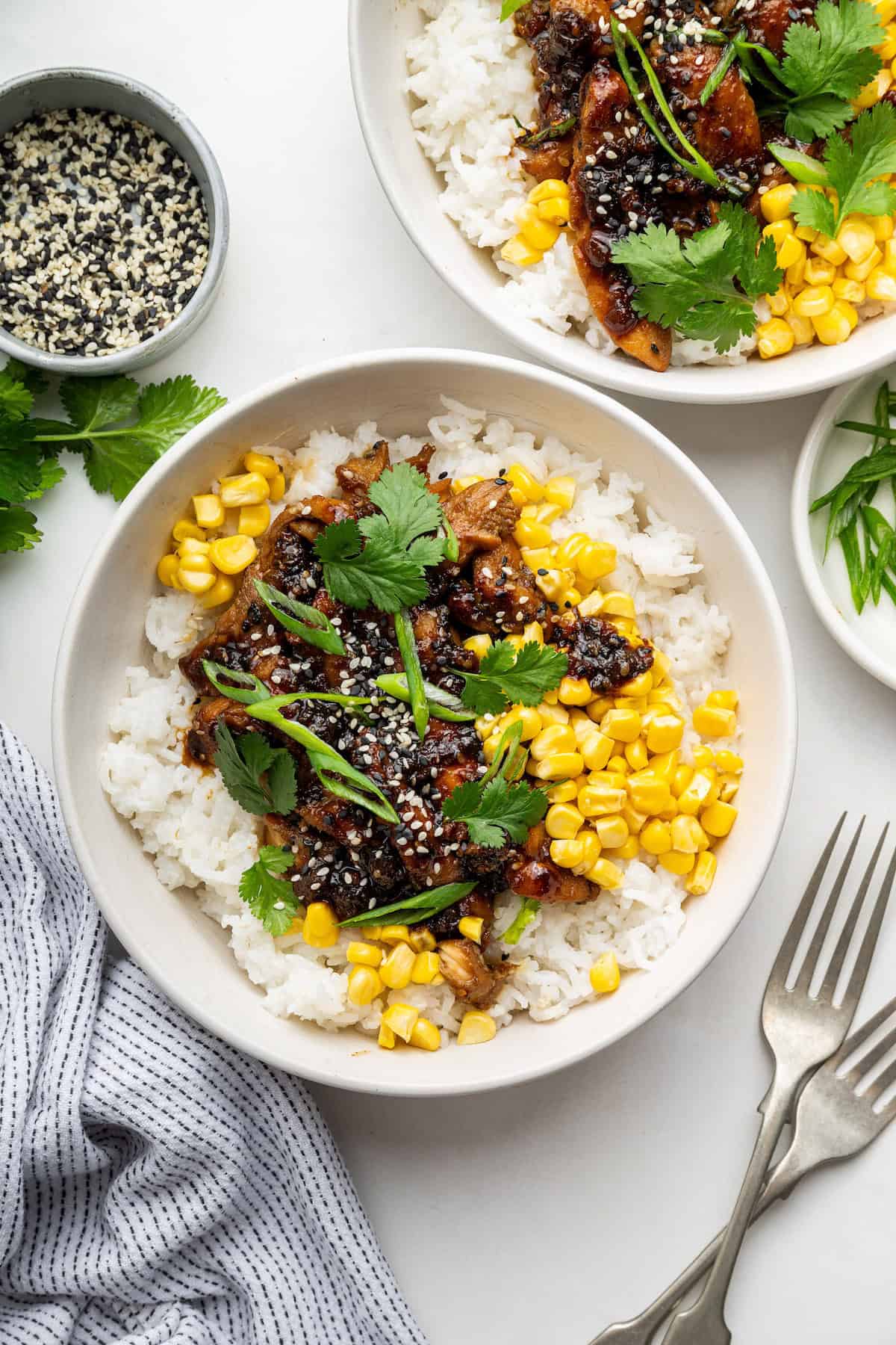 Overhead view of bulgogi in bowls with rice and corn