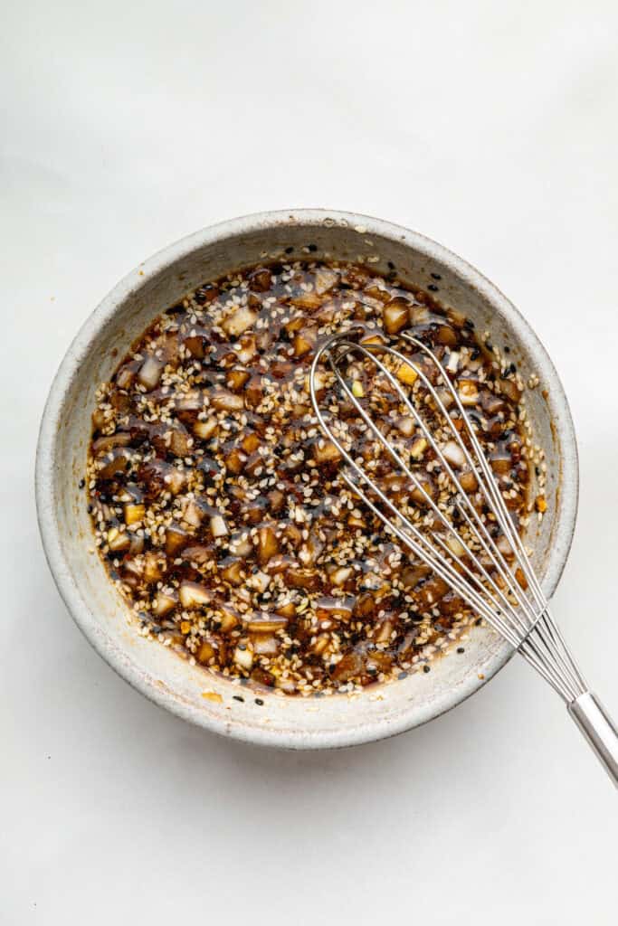 Whisking bulgogi marinade in bowl