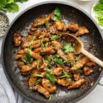 Bulgogi chicken in skillet with wooden spoon