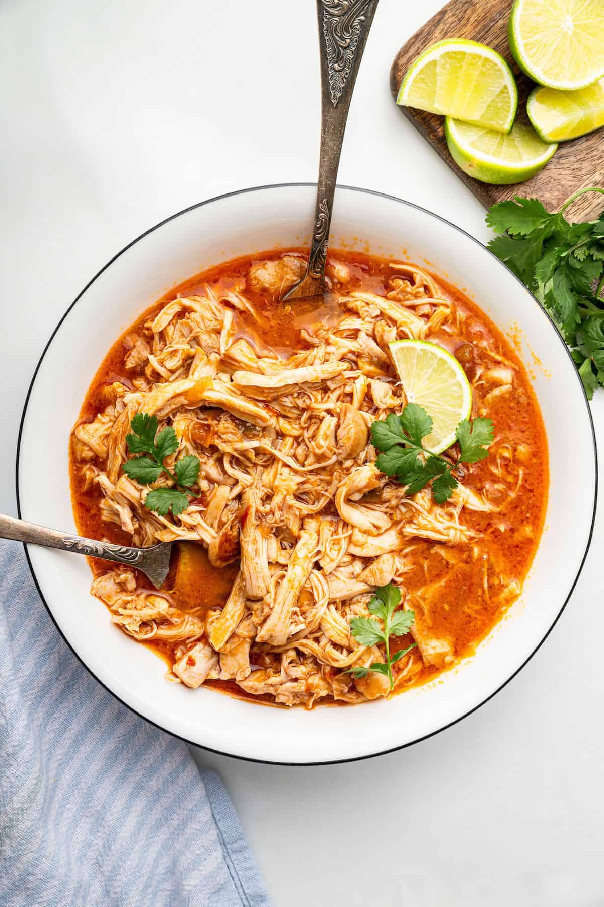 Overhead view of shredded salsa chicken with two forks