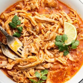 Shredded salsa chicken in bowl with forks