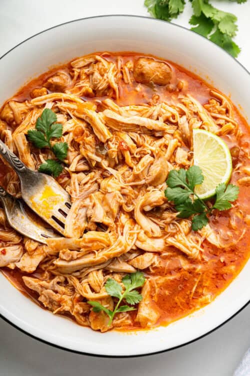 Shredded salsa chicken in bowl with forks