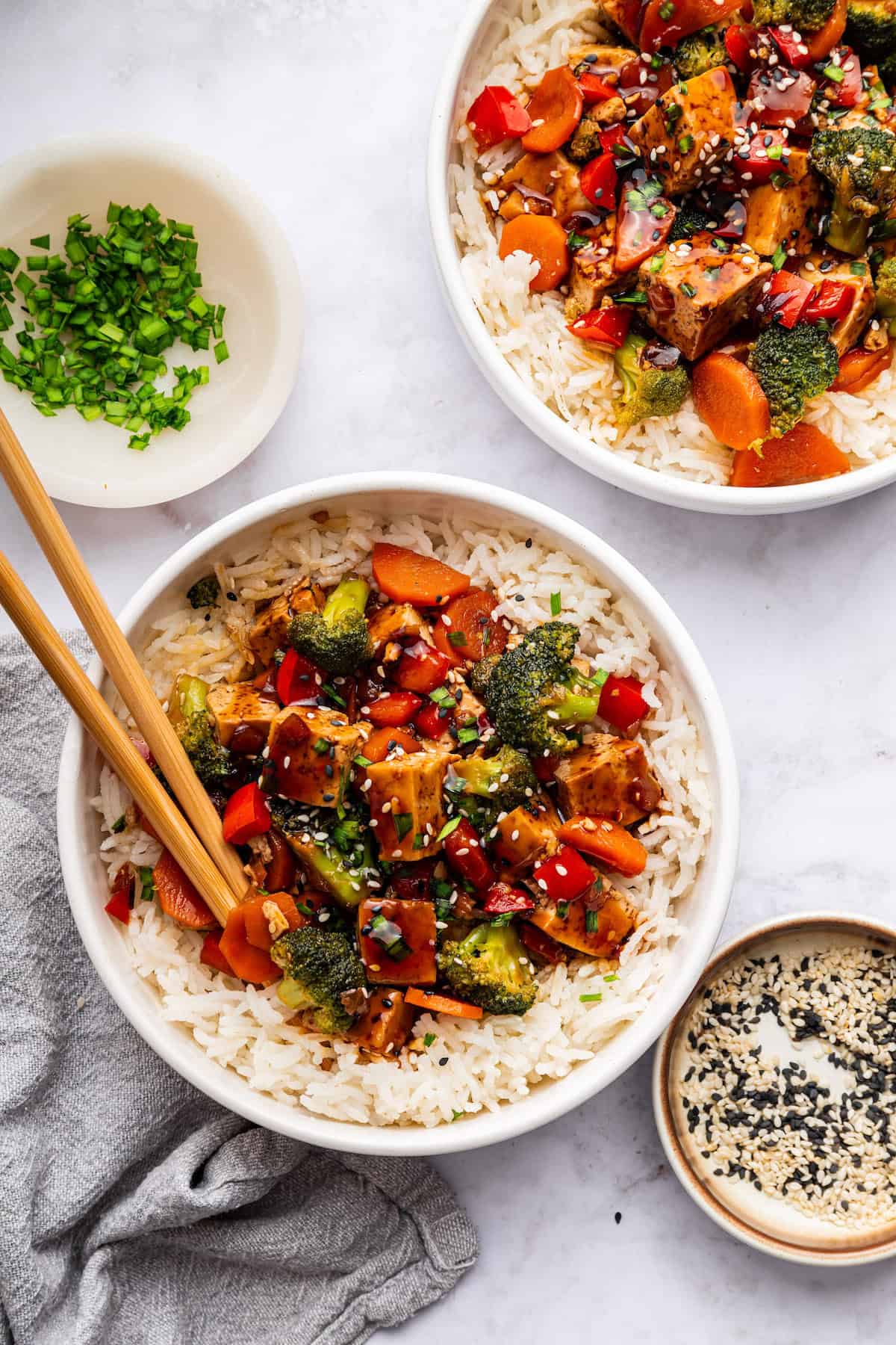 Overhead view of tofu stir fry in bowls